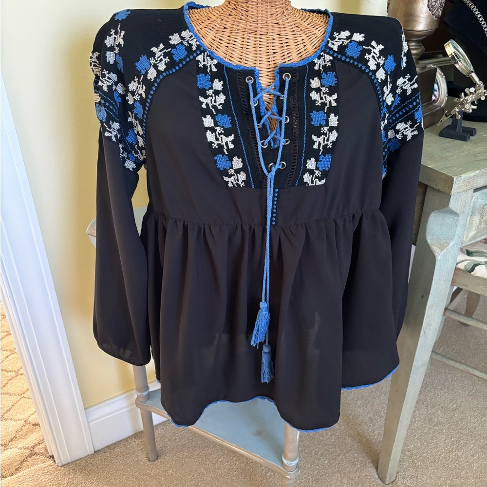 Cute black peasant style top with blue and white embroidery. Size small